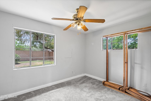 unfurnished room featuring carpet floors, ceiling fan, and baseboards
