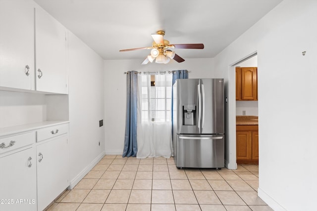 kitchen featuring light tile patterned floors, white cabinets, ceiling fan, light countertops, and stainless steel fridge with ice dispenser