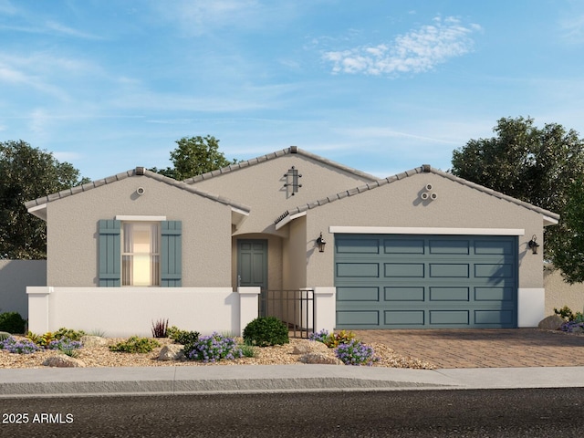 17834 W Pierson St, Goodyear, AZ 85395 - mediterranean / spanish house featuring decorative driveway, an attached garage, and stucco siding