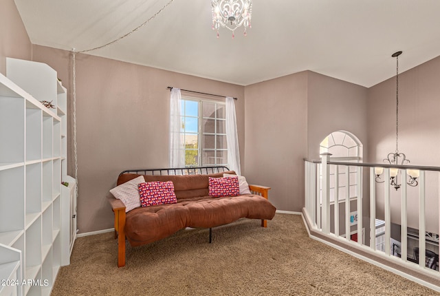 living area with carpet and an inviting chandelier