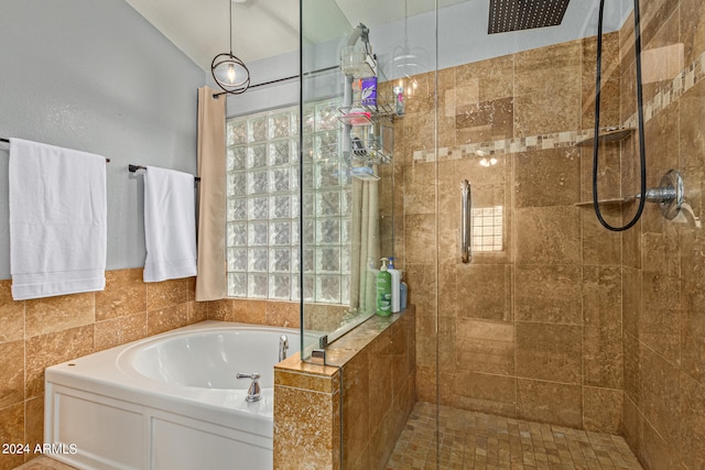 bathroom featuring shower with separate bathtub