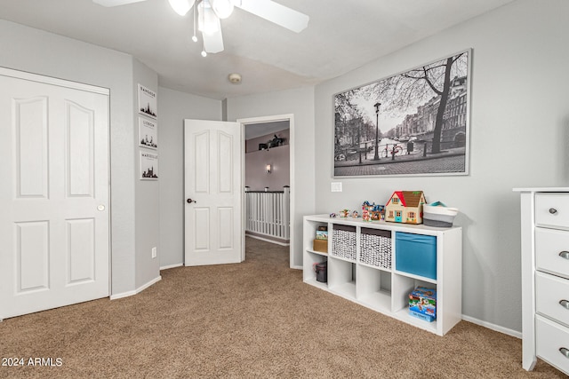 recreation room with carpet flooring and ceiling fan