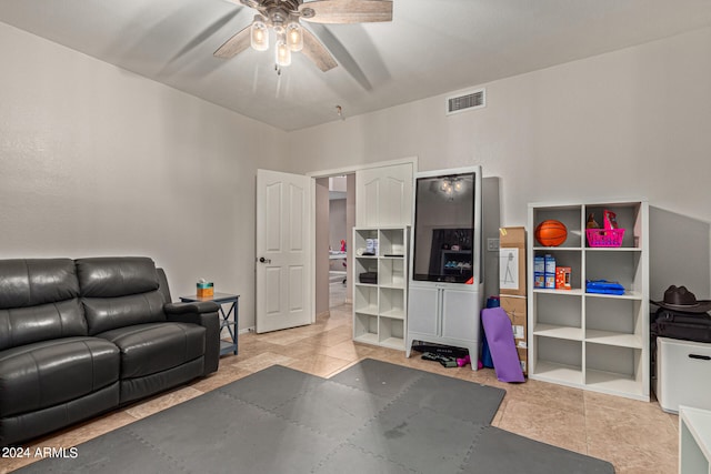 tiled living room featuring ceiling fan