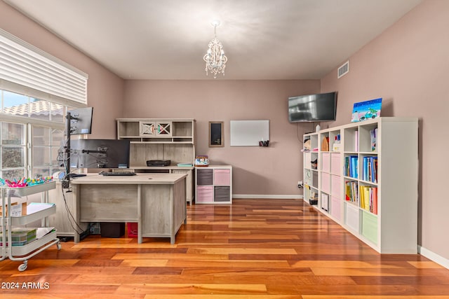 office space with hardwood / wood-style flooring and an inviting chandelier