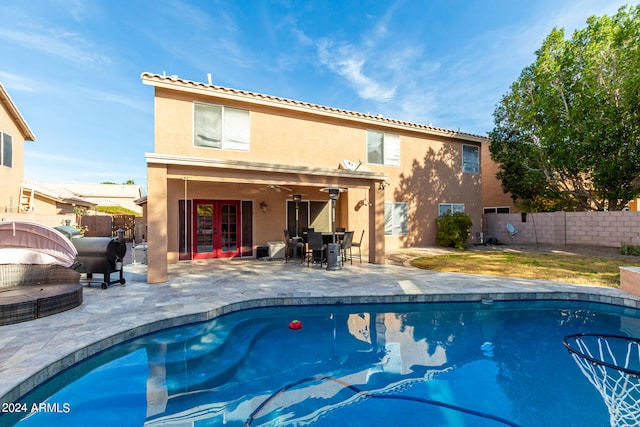 view of swimming pool with ceiling fan and a patio area