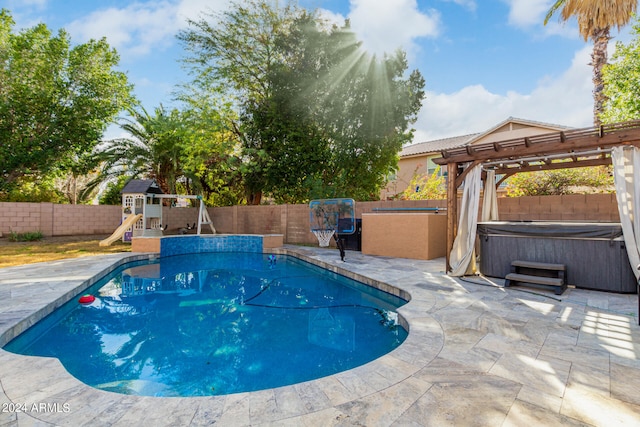 view of swimming pool featuring a pergola, a hot tub, and a patio