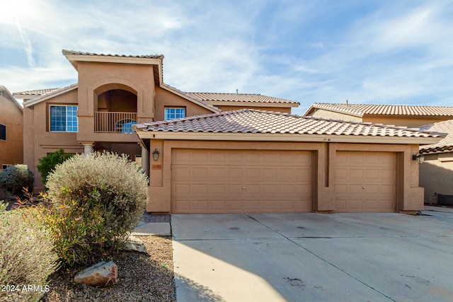 view of front of home with a garage and a balcony