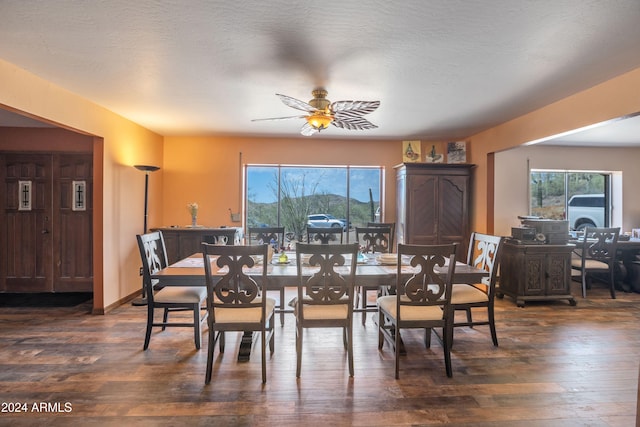 dining area featuring a textured ceiling, dark hardwood / wood-style floors, and ceiling fan