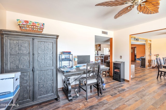 home office with ceiling fan and dark hardwood / wood-style flooring