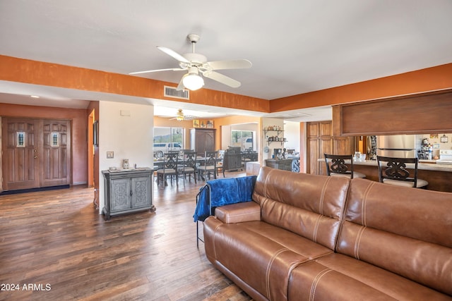 living room with dark wood-type flooring and ceiling fan