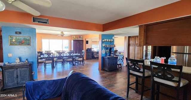 living room with dark hardwood / wood-style floors and ceiling fan