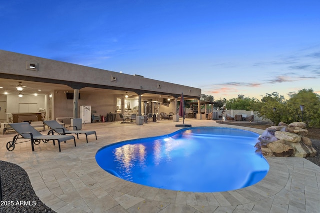 103 W Tanya Rd, Phoenix, AZ 85086 - pool at dusk featuring ceiling fan, a patio area, and an outdoor pool