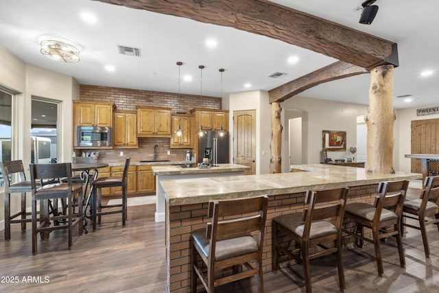103 W Tanya Rd, Phoenix, AZ 85086 - kitchen with tasteful backsplash, appliances with stainless steel finishes, a kitchen bar, a sink, and visible vents