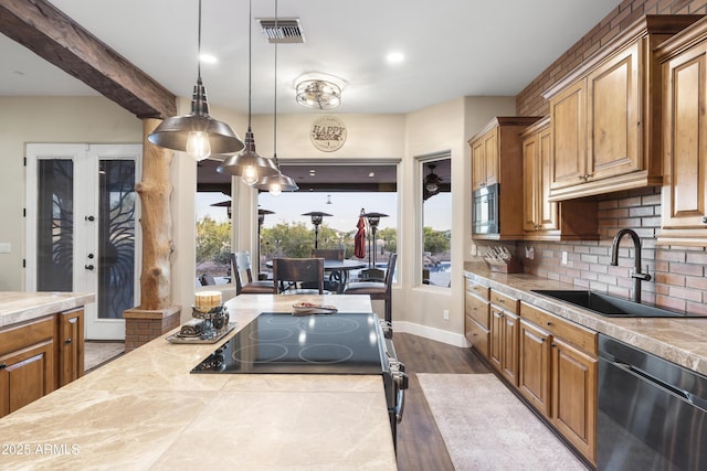 103 W Tanya Rd, Phoenix, AZ 85086 - kitchen featuring brown cabinets, a sink, stainless steel appliances, tasteful backsplash, and visible vents