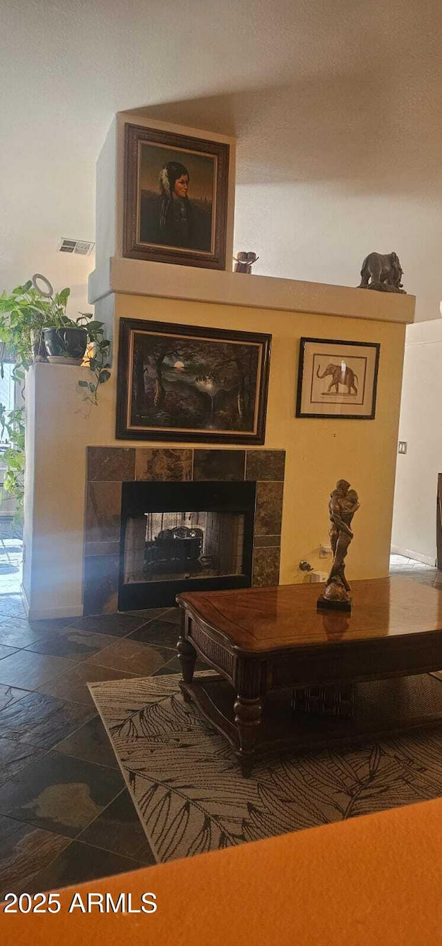 room details featuring visible vents and a fireplace