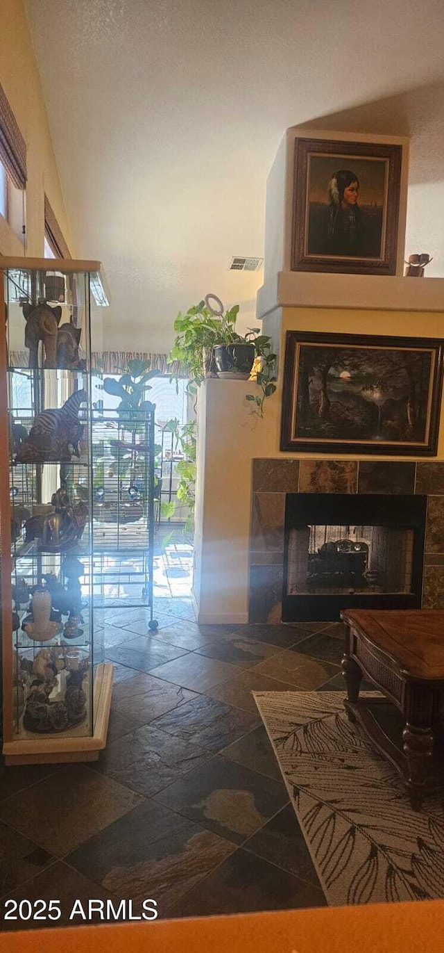 hallway with visible vents and stone tile flooring
