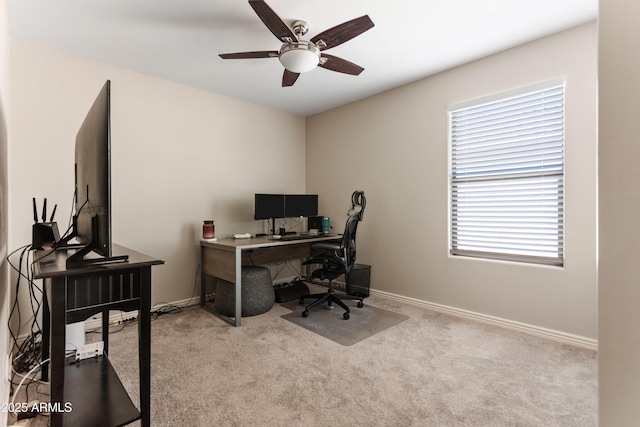 home office featuring carpet floors, baseboards, and a ceiling fan