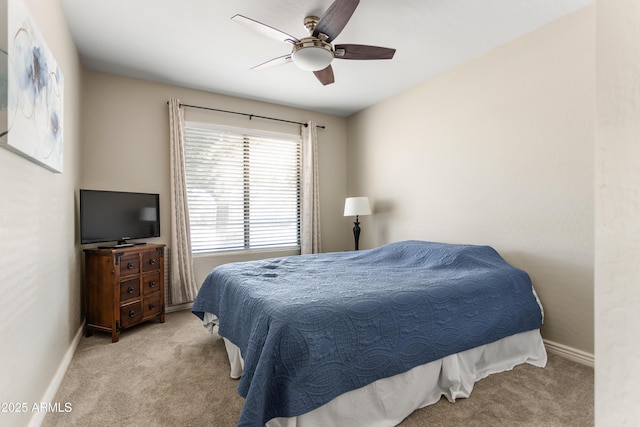 bedroom with ceiling fan, carpet flooring, and baseboards