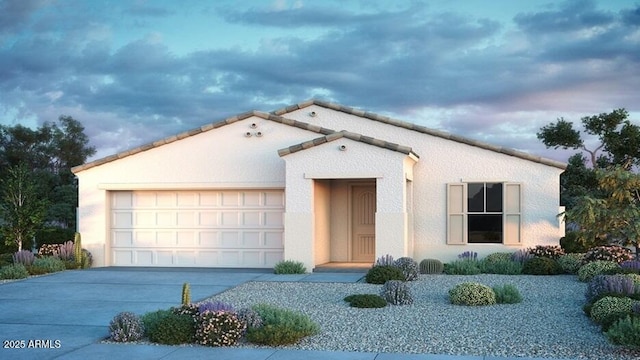 mediterranean / spanish-style home with a garage, driveway, and stucco siding