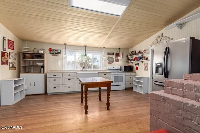 101 E Safford St, Tombstone, AZ 85638 - kitchen featuring pendant lighting, open shelves, light wood-style flooring, electric stove, and stainless steel refrigerator with ice dispenser