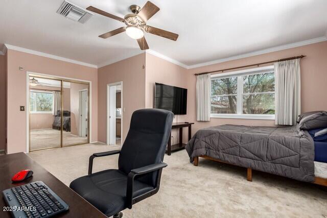 101 E Safford St, Tombstone, AZ 85638 - bedroom with light colored carpet, a closet, ornamental molding, visible vents, and a ceiling fan