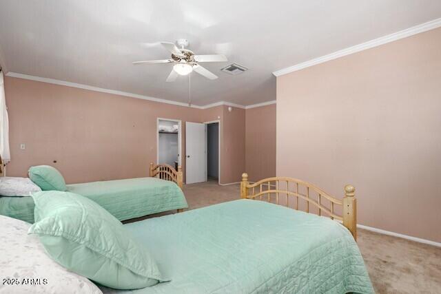 101 E Safford St, Tombstone, AZ 85638 - carpeted bedroom with ornamental molding, a ceiling fan, visible vents, and baseboards