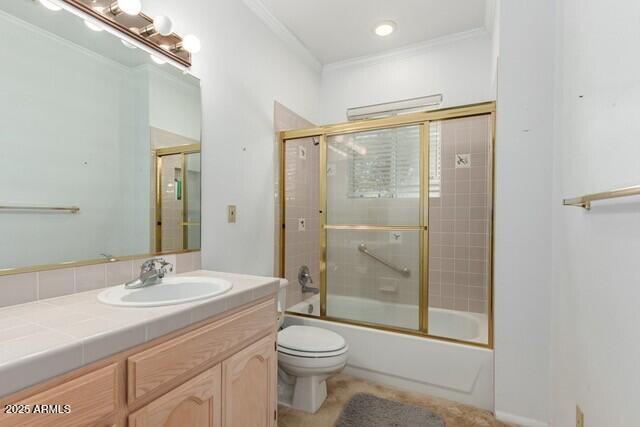 101 E Safford St, Tombstone, AZ 85638 - bathroom featuring bath / shower combo with glass door, toilet, crown molding, and vanity
