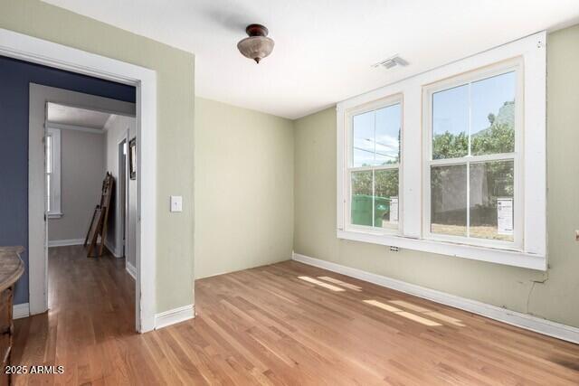 101 E Safford St, Tombstone, AZ 85638 - unfurnished room with visible vents, light wood-style flooring, and baseboards