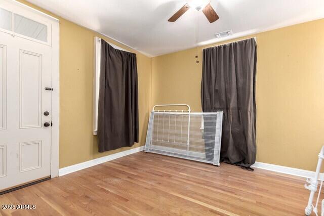 101 E Safford St, Tombstone, AZ 85638 - spare room featuring wood finished floors, a ceiling fan, visible vents, and baseboards