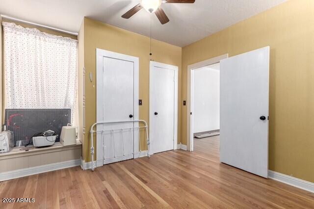 101 E Safford St, Tombstone, AZ 85638 - spare room with wood finished floors, ceiling fan, and baseboards