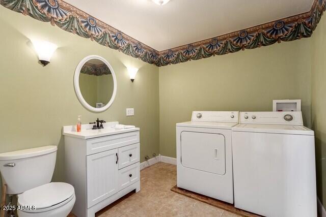 101 E Safford St, Tombstone, AZ 85638 - clothes washing area with light tile patterned floors, washing machine and clothes dryer, and laundry area