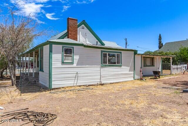 101 E Safford St, Tombstone, AZ 85638 - view of side of property with a chimney