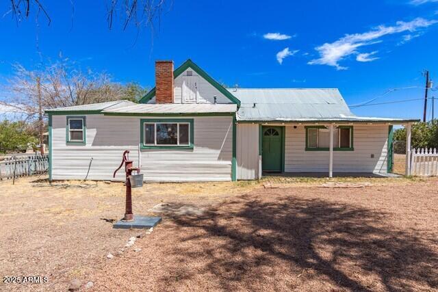 101 E Safford St, Tombstone, AZ 85638 - view of front facade featuring fence and a chimney