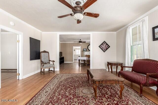 101 E Safford St, Tombstone, AZ 85638 - sitting room featuring baseboards, ornamental molding, a ceiling fan, and wood finished floors