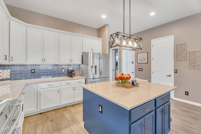 21266 S 213th Pl, Queen Creek, AZ 85142 - kitchen with stainless steel refrigerator with ice dispenser, blue cabinetry, white cabinets, light wood-style floors, and decorative backsplash