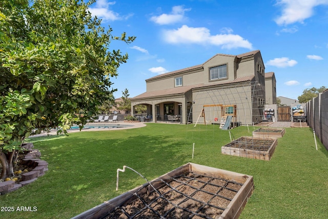 21266 S 213th Pl, Queen Creek, AZ 85142 - rear view of property featuring a vegetable garden, stucco siding, and a patio area