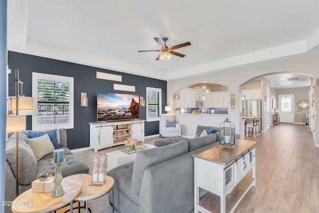 21266 S 213th Pl, Queen Creek, AZ 85142 - living area featuring arched walkways, a ceiling fan, plenty of natural light, and baseboards