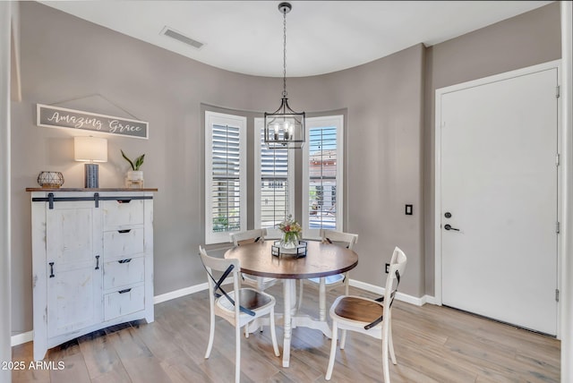 21266 S 213th Pl, Queen Creek, AZ 85142 - dining room featuring light wood finished floors, a chandelier, and baseboards
