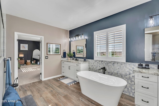 21266 S 213th Pl, Queen Creek, AZ 85142 - full bathroom featuring wood finished floors, a freestanding bath, vanity, and wainscoting
