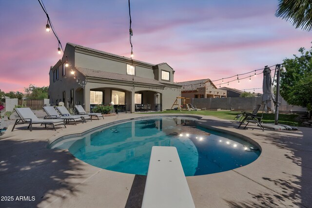 21266 S 213th Pl, Queen Creek, AZ 85142 - pool at dusk with a patio area and a diving board