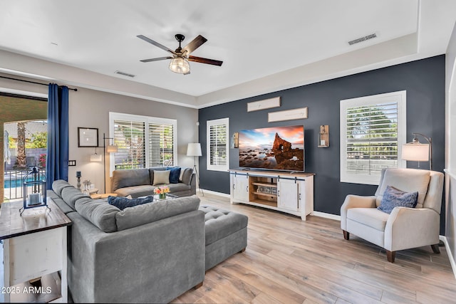 21266 S 213th Pl, Queen Creek, AZ 85142 - living area featuring ceiling fan, baseboards, light wood finished floors, and plenty of natural light