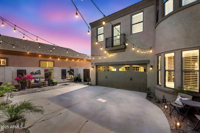 21266 S 213th Pl, Queen Creek, AZ 85142 - view of front facade with stucco siding, concrete driveway, a balcony, and a garage