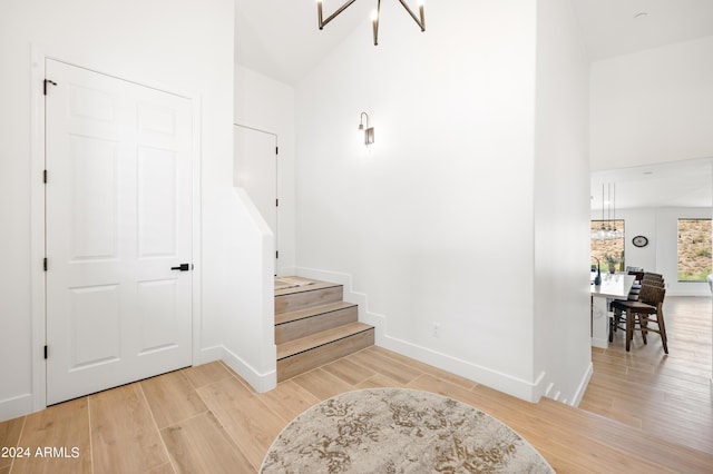 stairway featuring an inviting chandelier