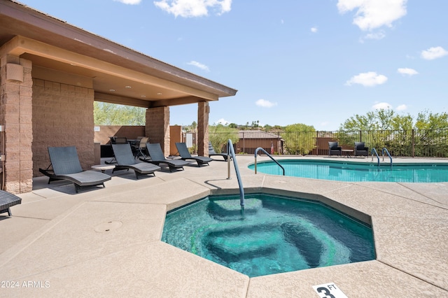 view of swimming pool with a community hot tub and a patio