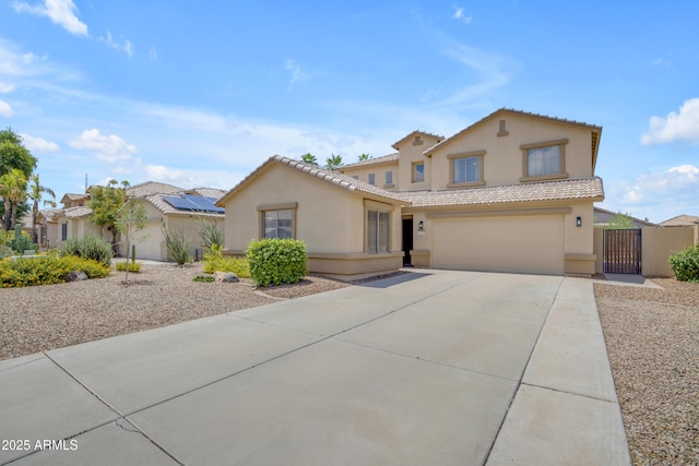 3349 E Flamingo Ct, Gilbert, AZ 85297 - mediterranean / spanish-style house featuring stucco siding, a gate, concrete driveway, an attached garage, and a tile roof