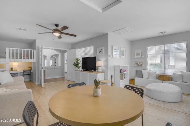 3349 E Flamingo Ct, Gilbert, AZ 85297 - living area featuring light wood-style flooring, healthy amount of natural light, a ceiling fan, and baseboards