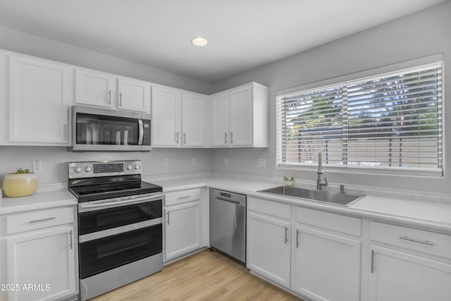 3349 E Flamingo Ct, Gilbert, AZ 85297 - kitchen featuring stainless steel appliances, a sink, light countertops, white cabinetry, and recessed lighting