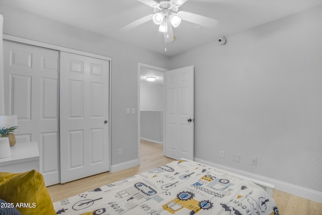 3349 E Flamingo Ct, Gilbert, AZ 85297 - bedroom with light wood finished floors, a closet, baseboards, and a ceiling fan