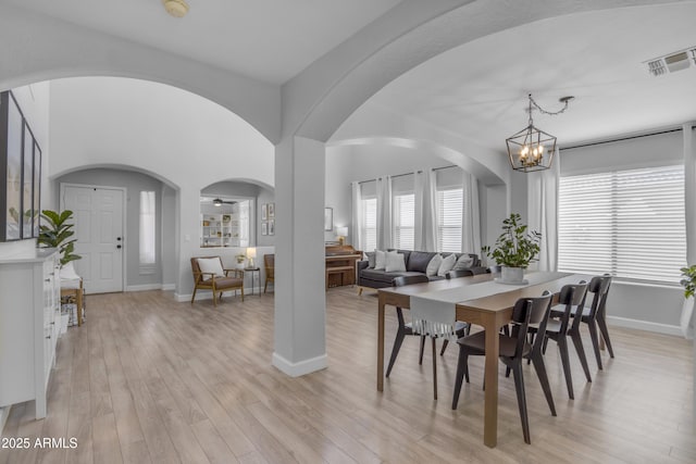 3349 E Flamingo Ct, Gilbert, AZ 85297 - dining area with arched walkways, light wood finished floors, and baseboards