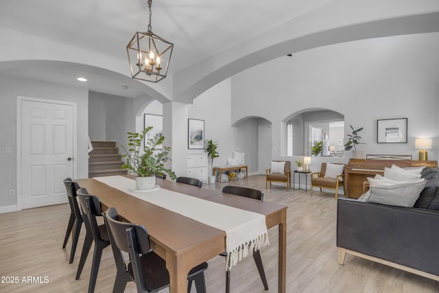 3349 E Flamingo Ct, Gilbert, AZ 85297 - dining room featuring arched walkways, a chandelier, stairs, light wood-style floors, and recessed lighting